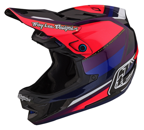 Red, black, and blue Troy Lee Designs helmet on a white background