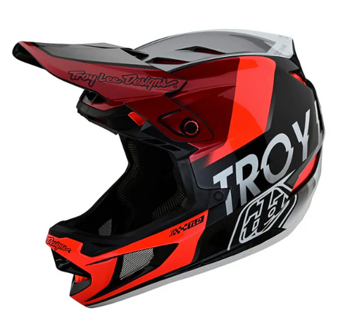 Red and black Troy Lee Designs helmet on a white background