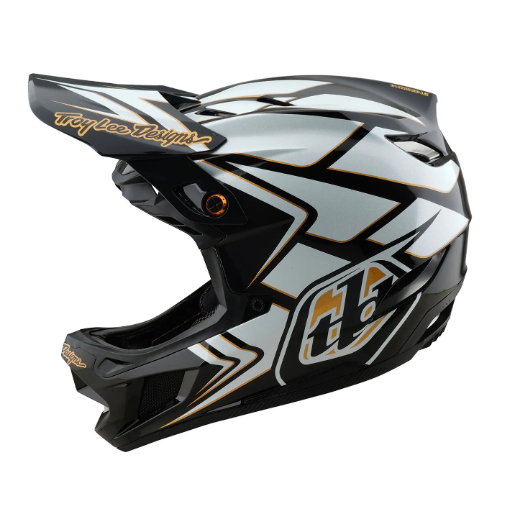 Motocross helmet with black, white, and gold design on a white background