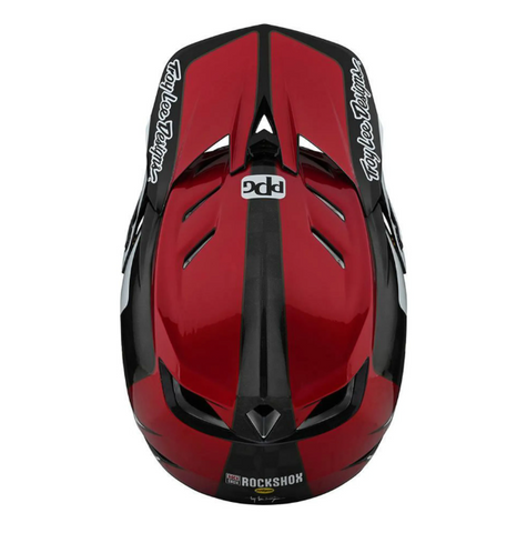 Red and black helmet with visible branding on a white background